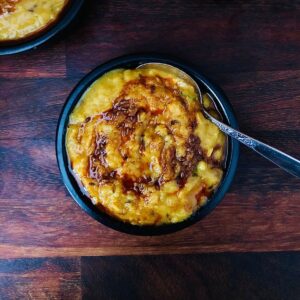 A shallow dish containing daal with tempered tadka.