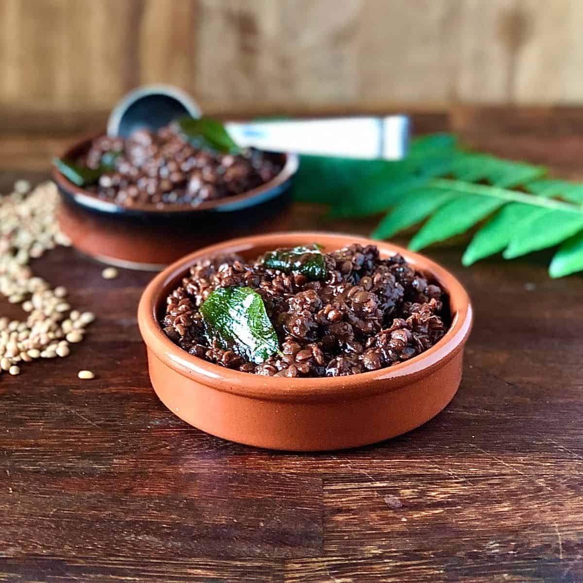 A shallow dish containing horse gram daal.