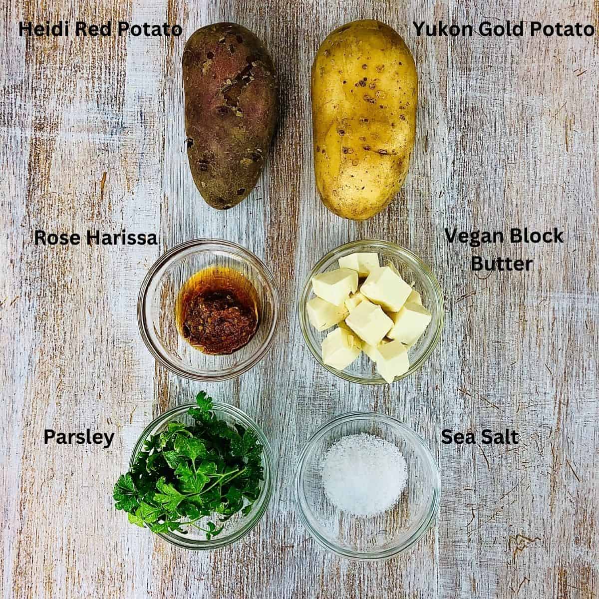 Ingredients laid out for pomme anna: potato, rose Harissa, vegan block butter, salt and parsley.