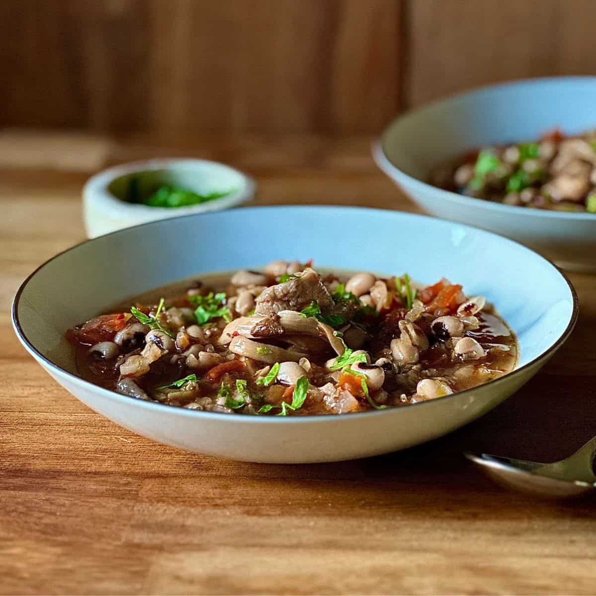 A bowl containing black-eye pea and mushroom stew.