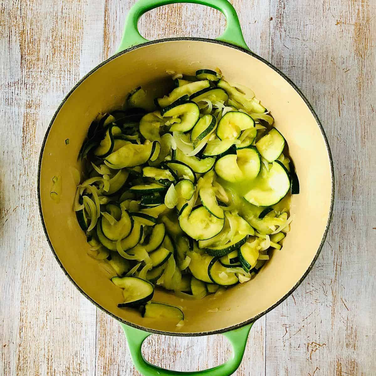 A saucepan containing cooked ingredients for courgette pasta sauce, ready to blend to a puree.