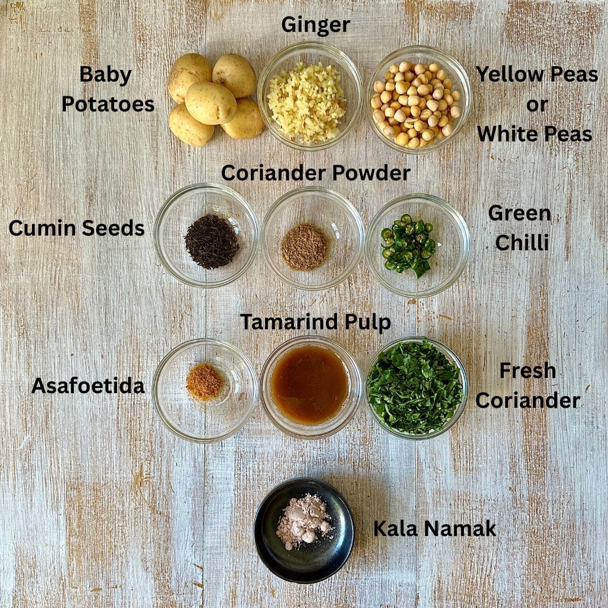 Prepared ingredients for hasselback potato matar ki chaat in small glass dishes, annotated.