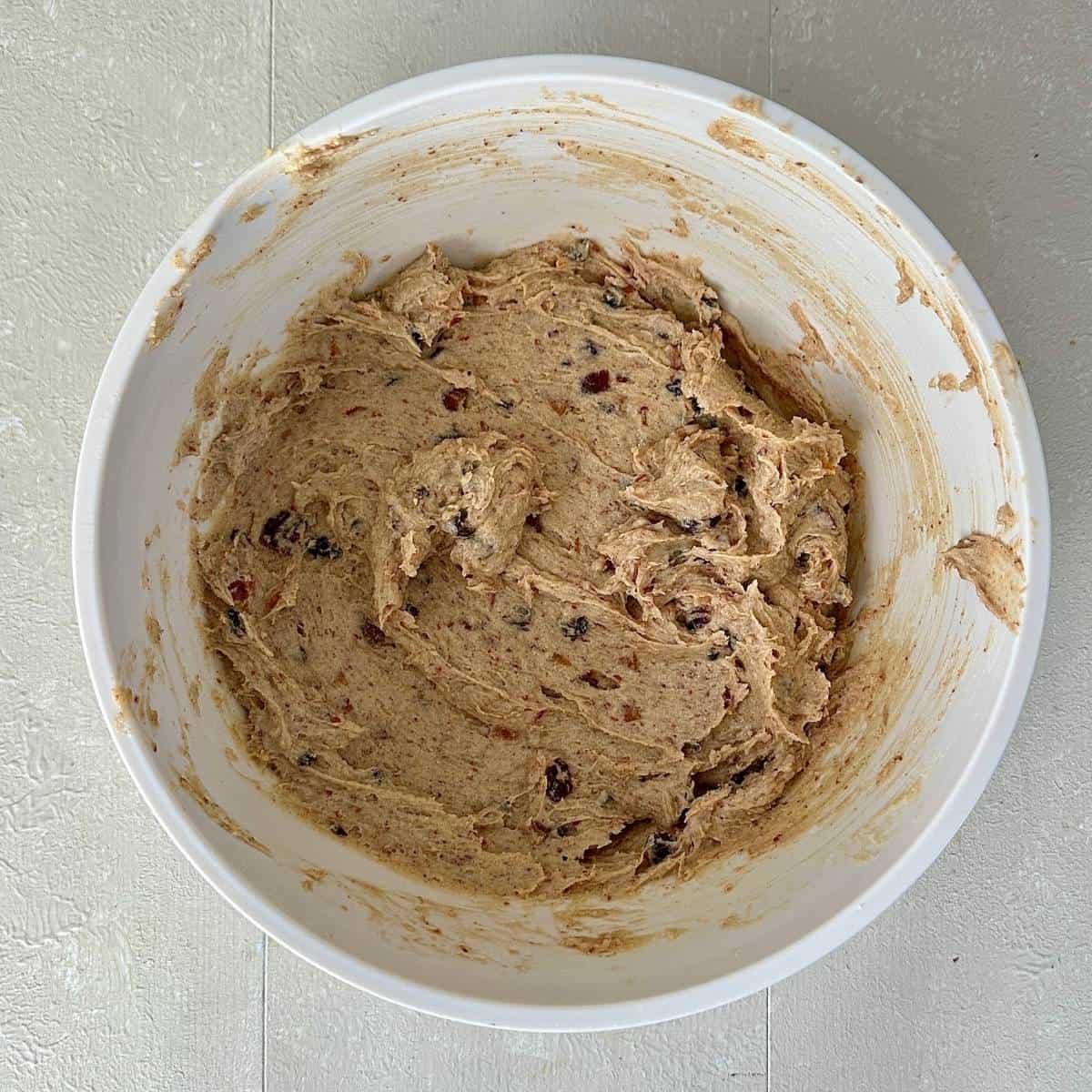A white bowl containing Christmas vegan cupcake dough.