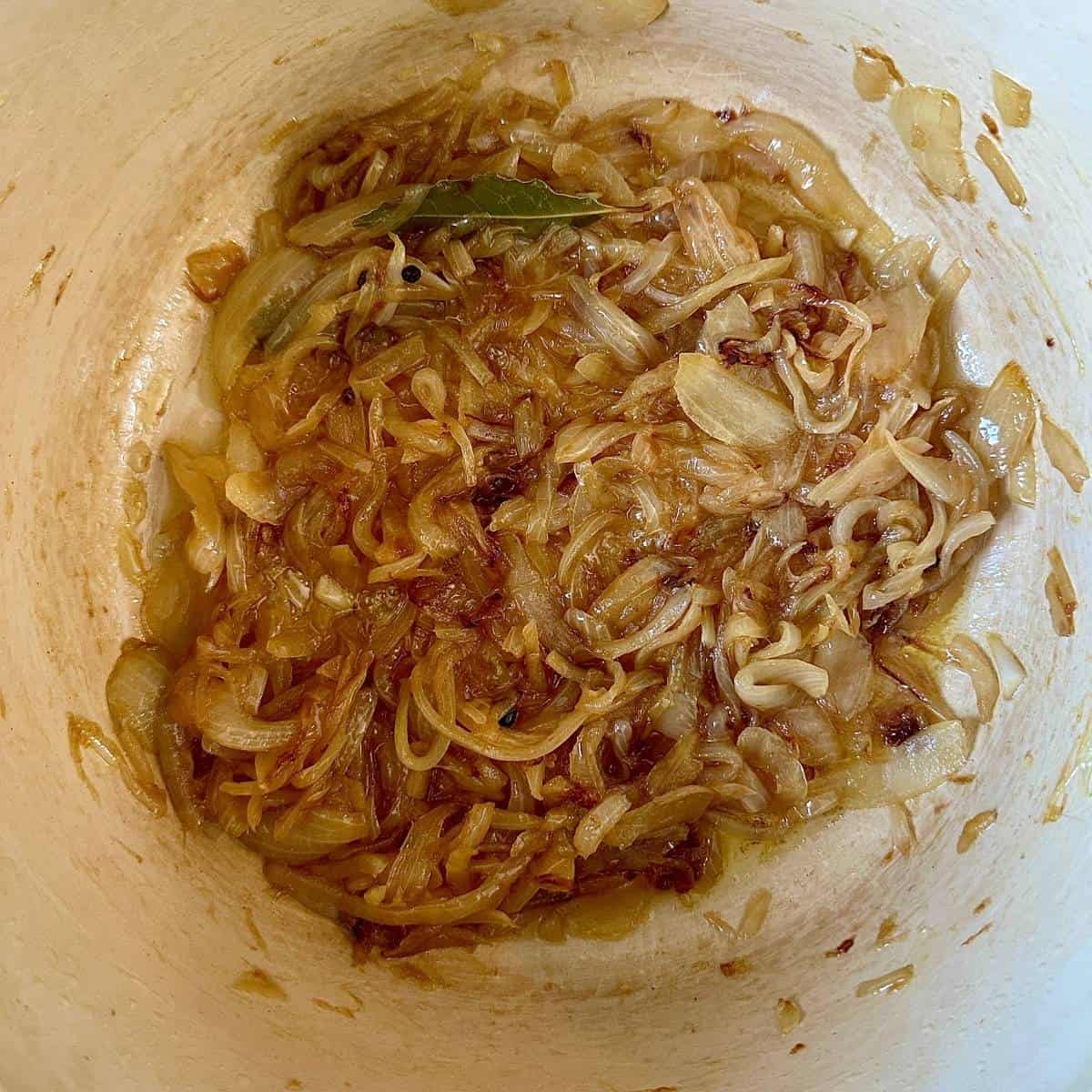 Close-up shot of caramelised onion for onion and leek soup recipe.