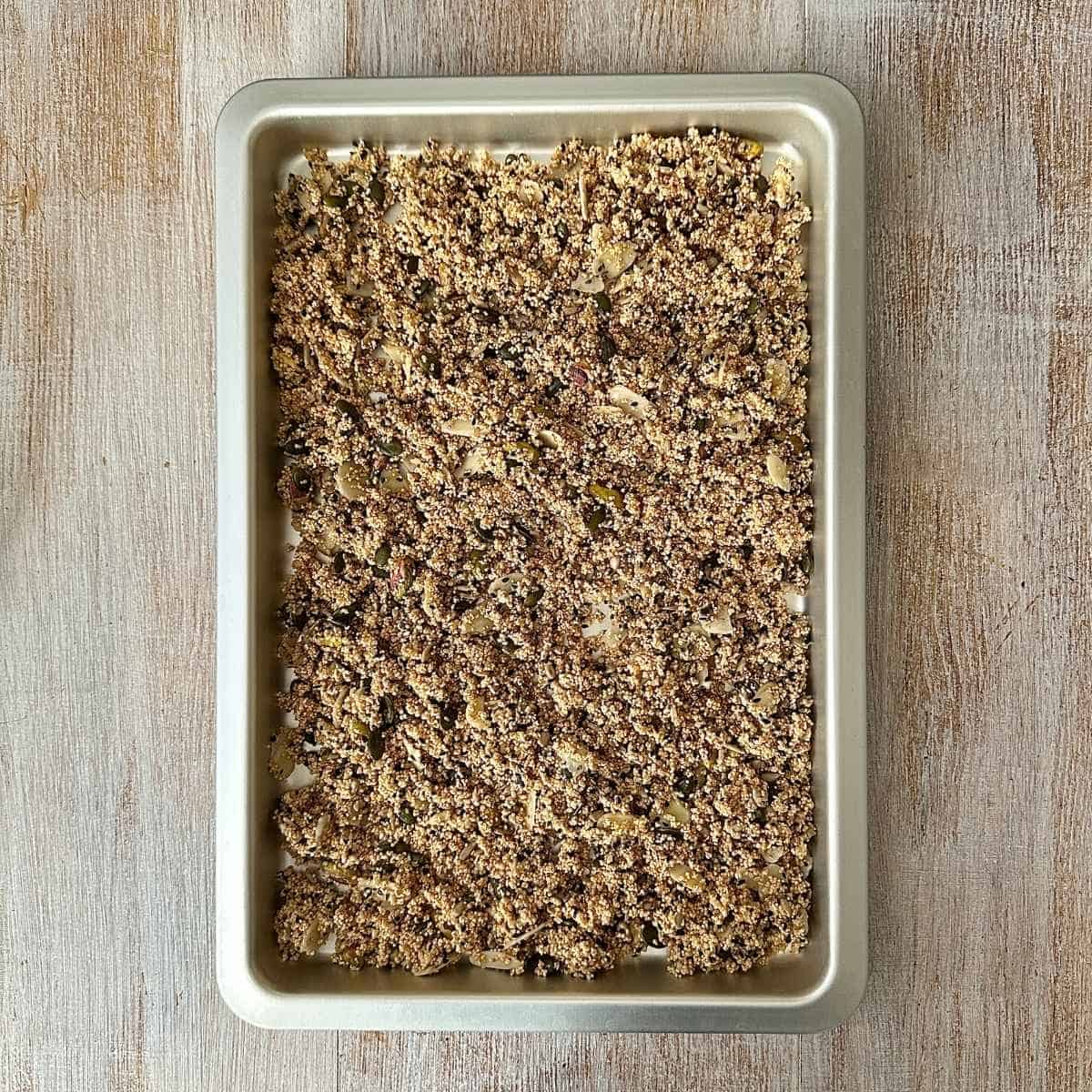 A baking tray containing sugar free granola mix ready to roast in the oven.