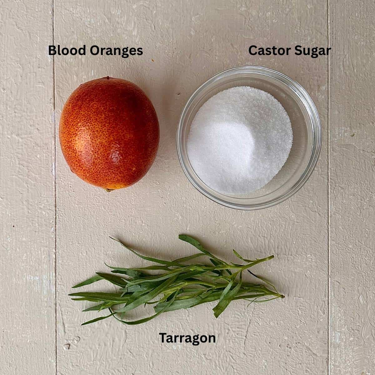 Ingredients for blood orange granita on a white background. The Ingredients are annotated.