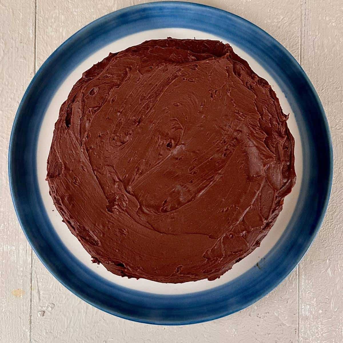 Overhead shot of a dark chocolate mud cake with a dark chocolate Ganache spread on top.