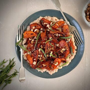 Spicy gochujang roasted carrots with creamy white beans, a plant-based main or side dish