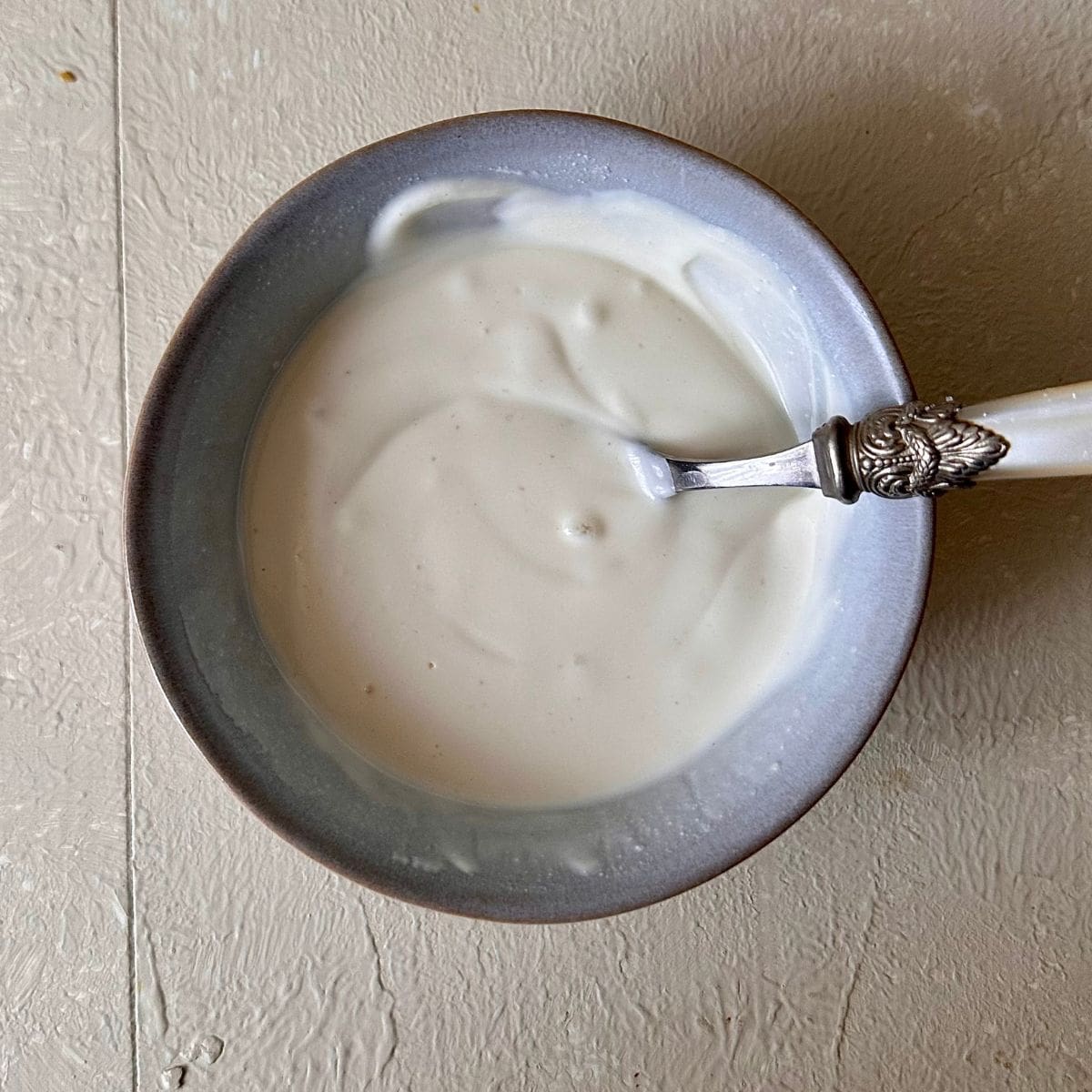 A dish containing tahini yoghurt for black eyed peas with smoked tofu recipe.
