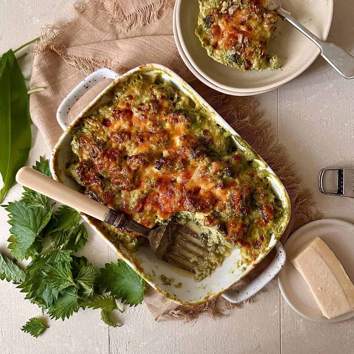 Wild garlic cauliflower cheese with nettles served with a plated portion.