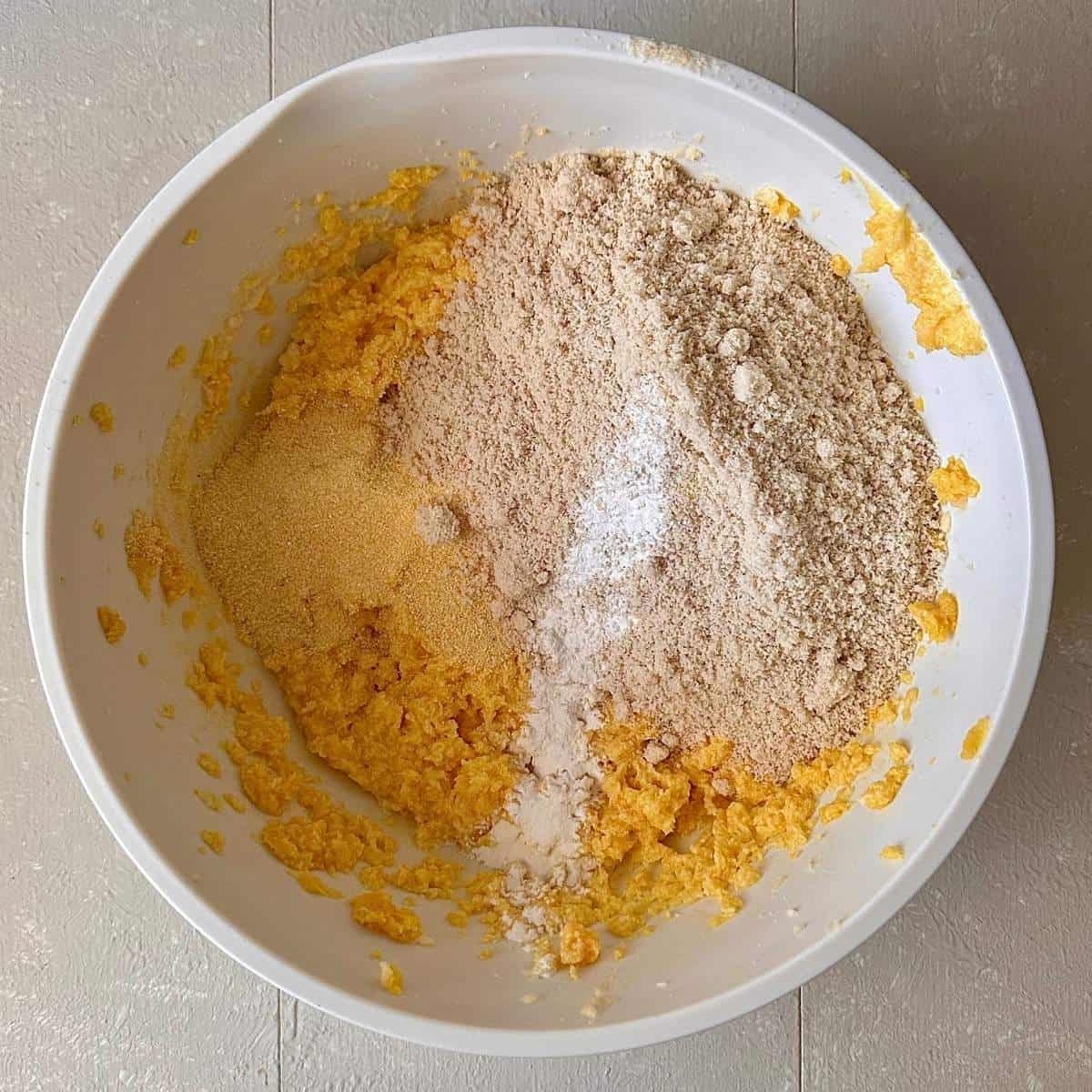Orange polenta cake batter mix with polenta, ground almonds and baking powder added, ready to fold in.