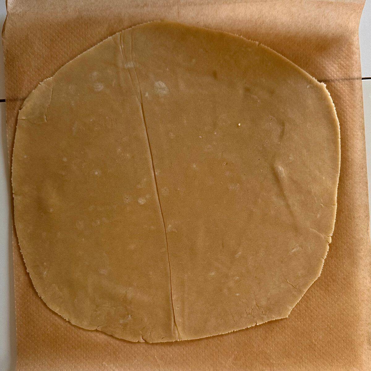 Shortcrust pastry rolled out to 3mm thick, sat on parchment paper. For a beetroot and goats cheese tart.