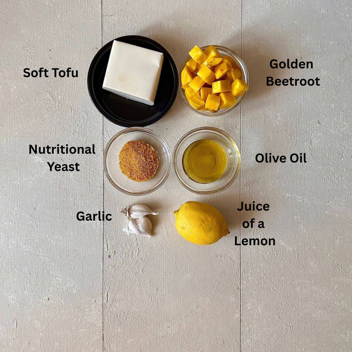 Ingredients for beetroot dip recipe laid on a white background. The ingredients are annotated.