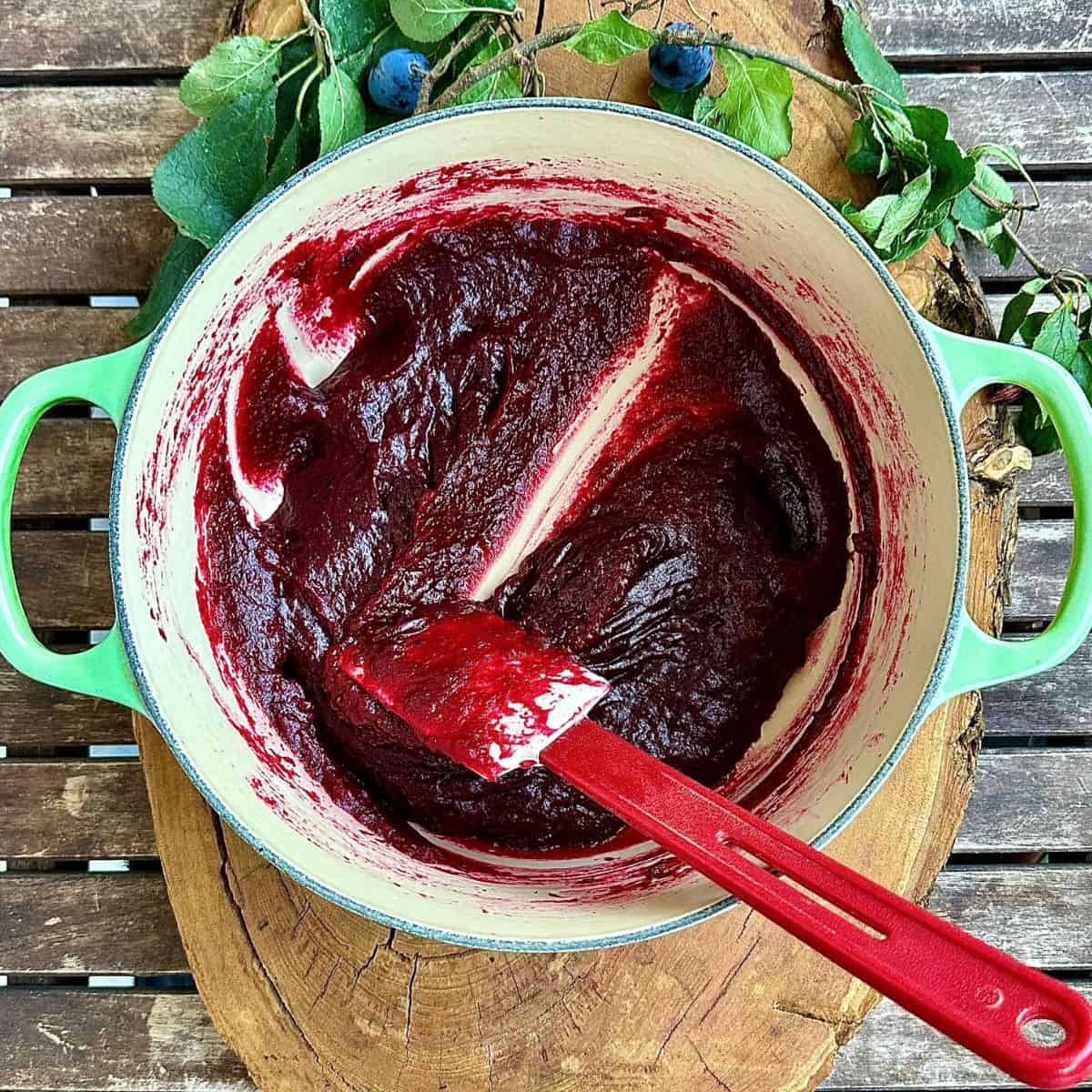 A large green pot containing crab apple and damson pulp mixed with water and sugar, cook and reduced down to a paste. For a fruit leather recipe.