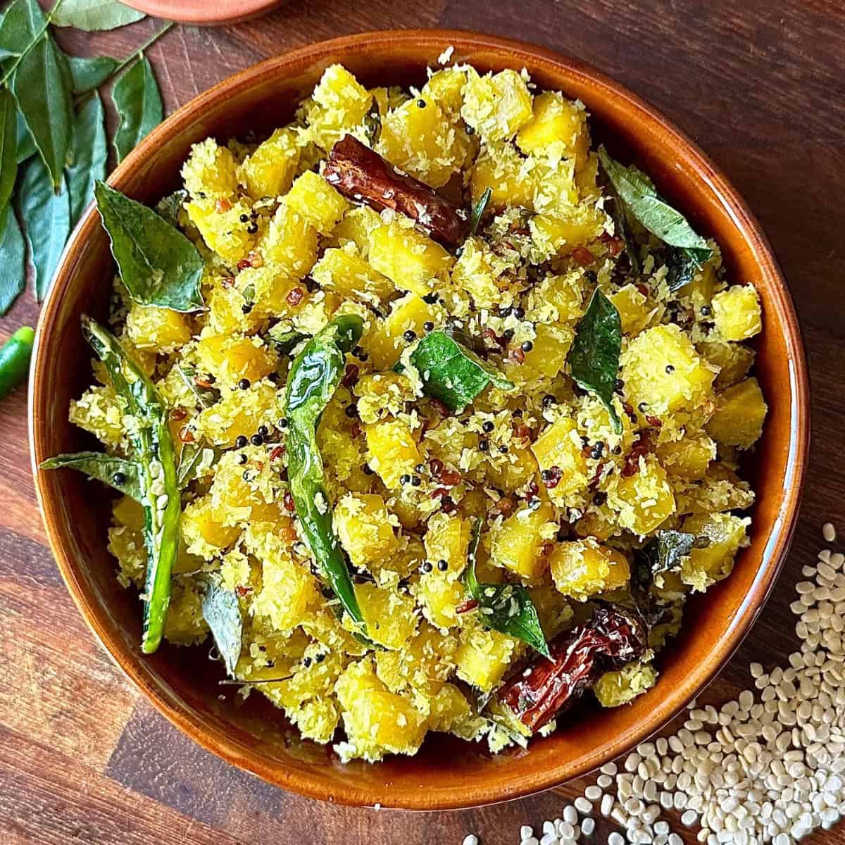 Golden beetroot thoran in a bowl with coconut and curry leaves.