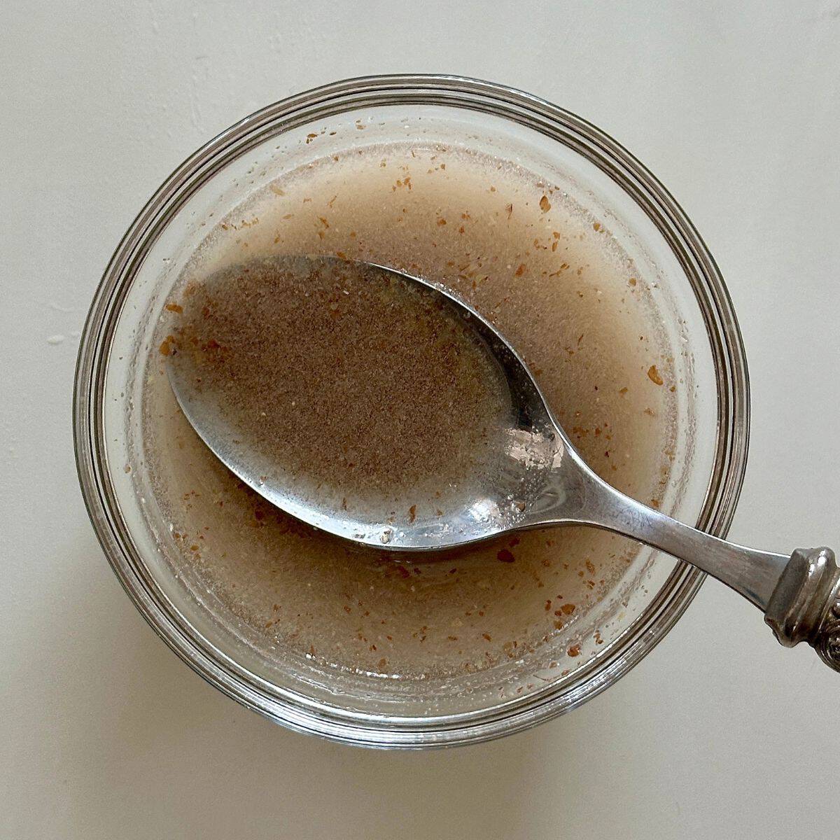 A small bowl containing ground flaxseed mixed into lukewarm water. For a quince frangipane tart recipe.
