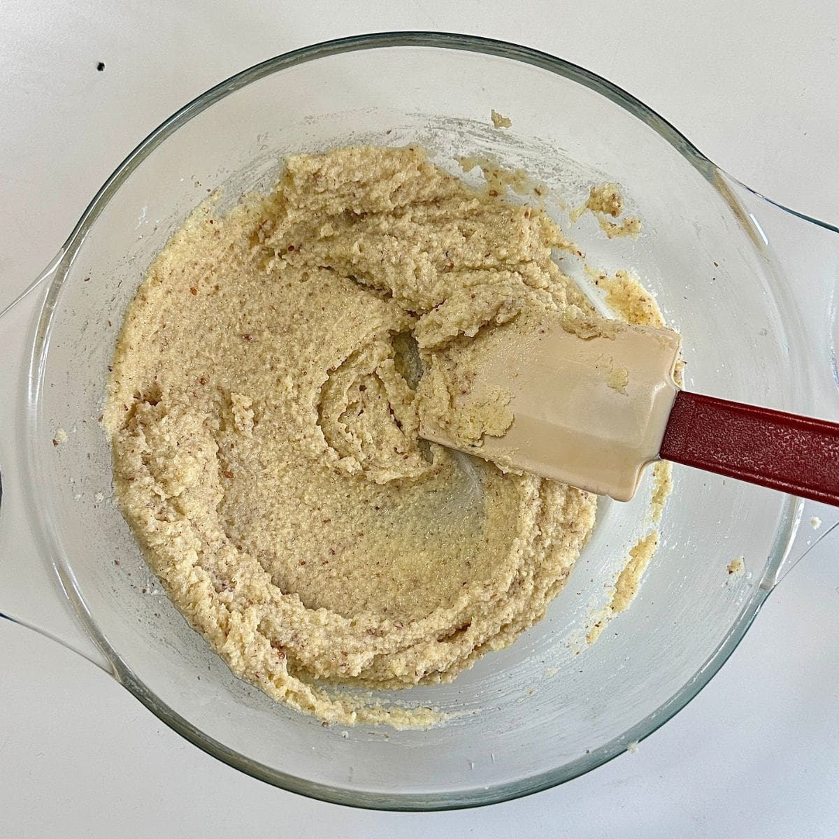 A glass bowl containing frangipane mixture for a quince frangipane tart recipe.