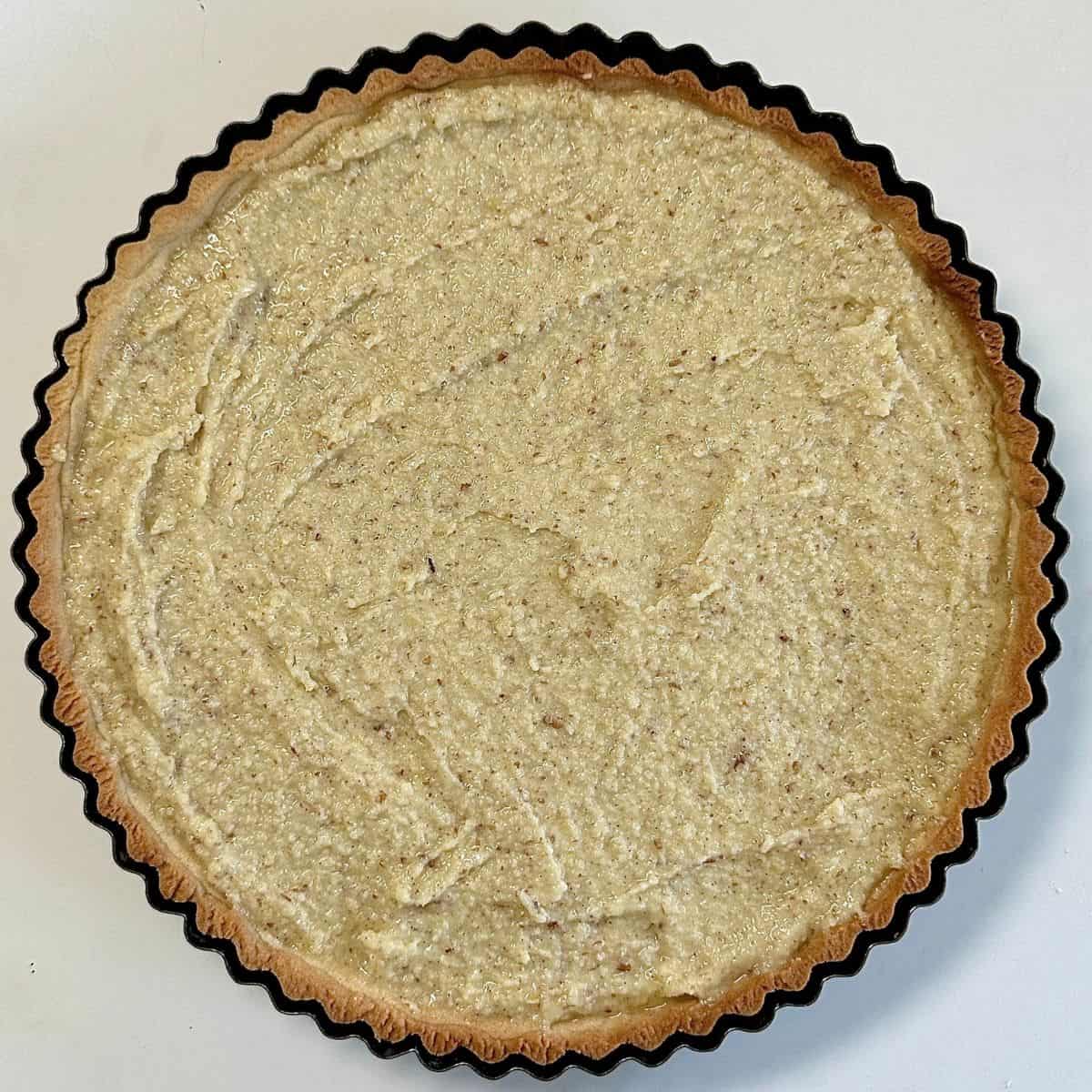 A pastry tart case with a layer of frangipane at the bottom. For a quince frangipane tart recipe.