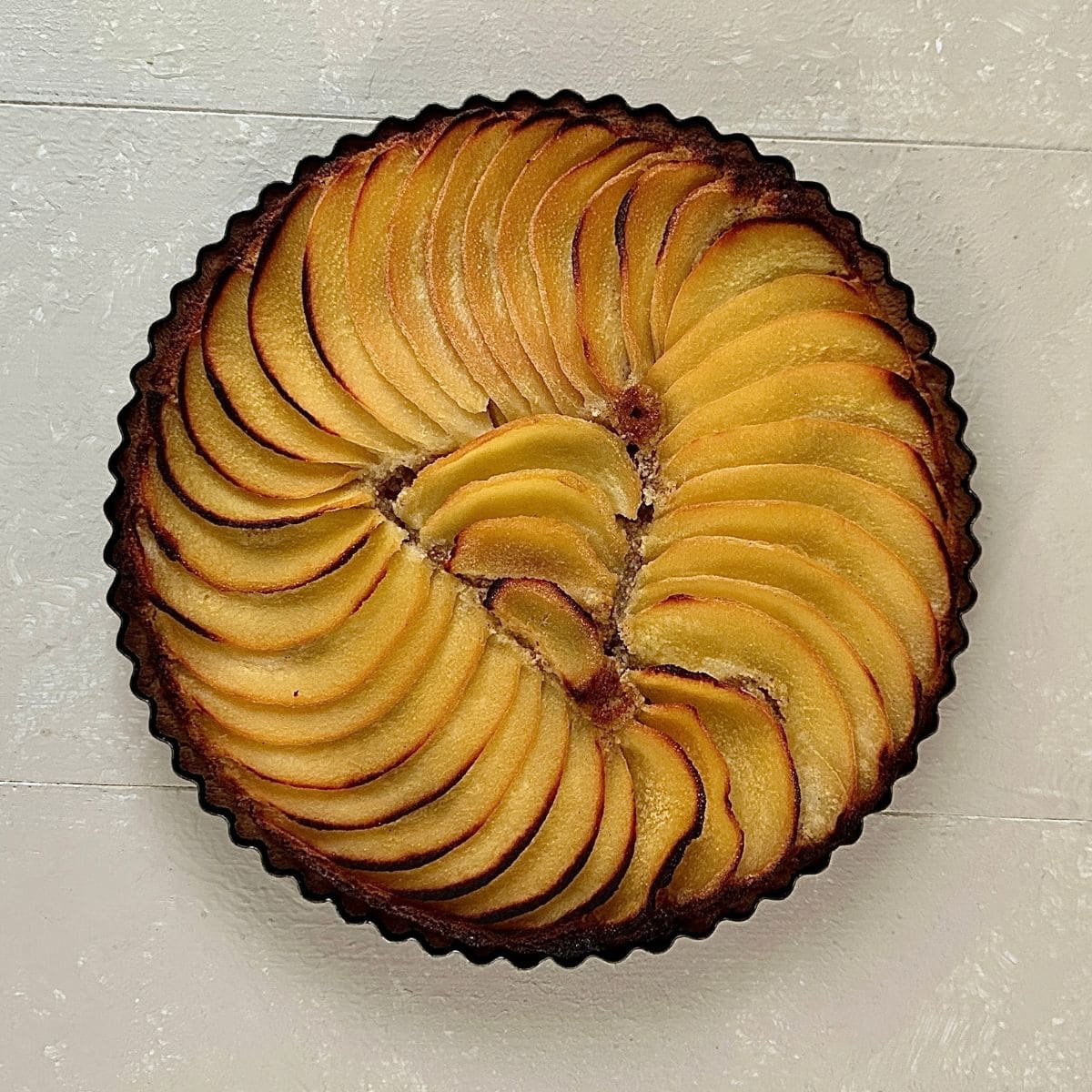 A quince frangipane tart after baking in an oven.